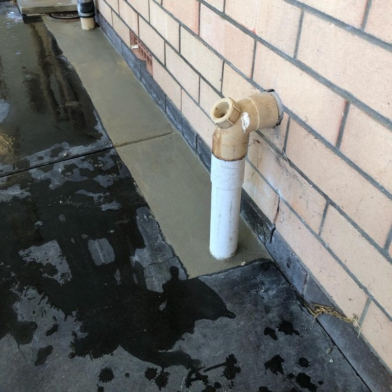 Plumber clearing a blocked drain in Perth
